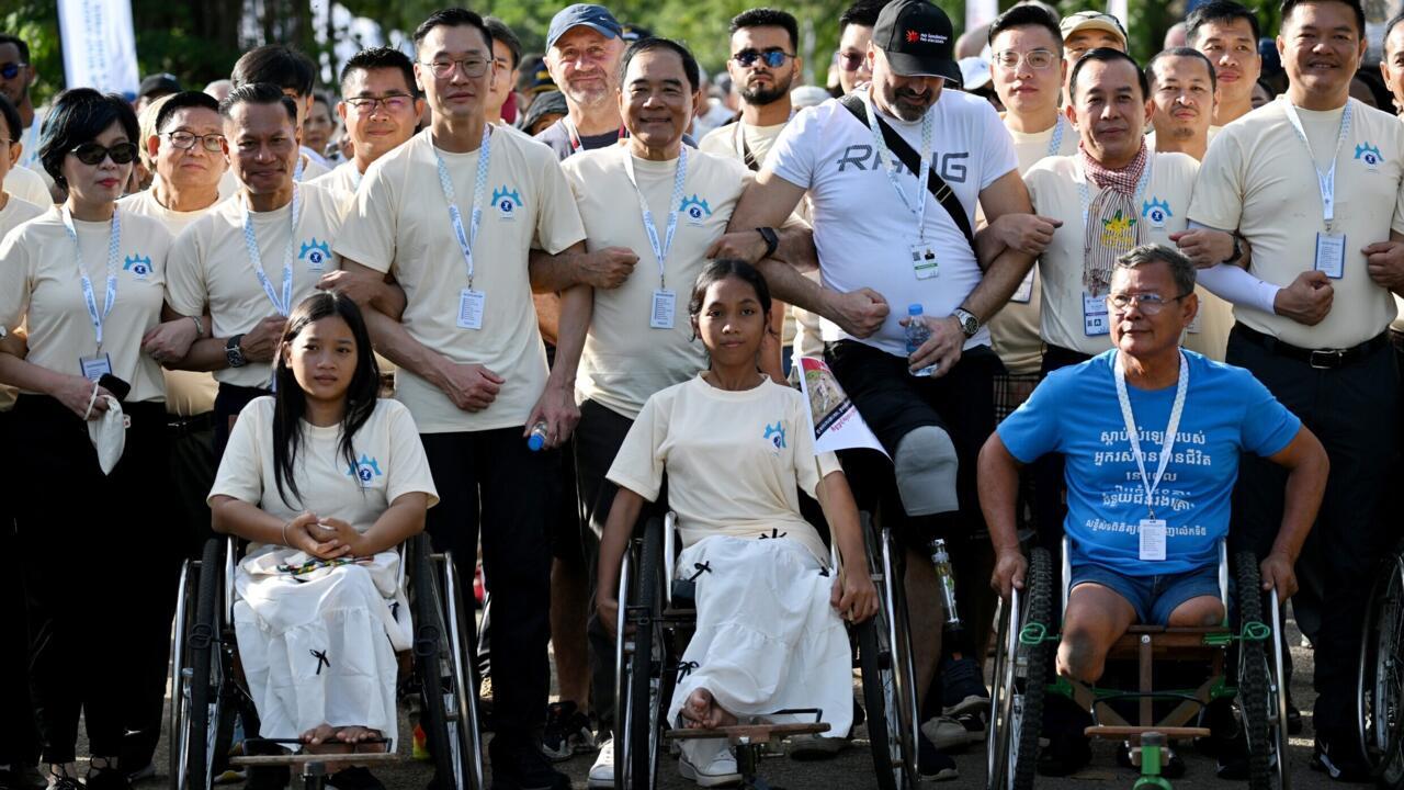 Survivors, sniffing dogs join anti-mine march at Cambodia's Angkor Wat