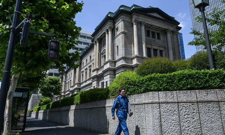 Bank of Japan holds rates, says to slow bond purchase taper