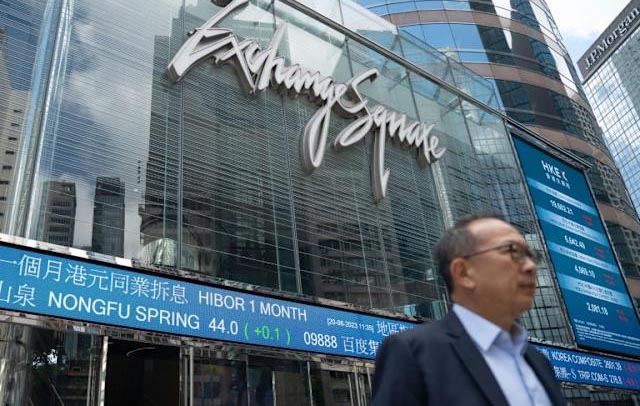 Asian stocks drop after Fed warning, oil dips with Mideast in focus