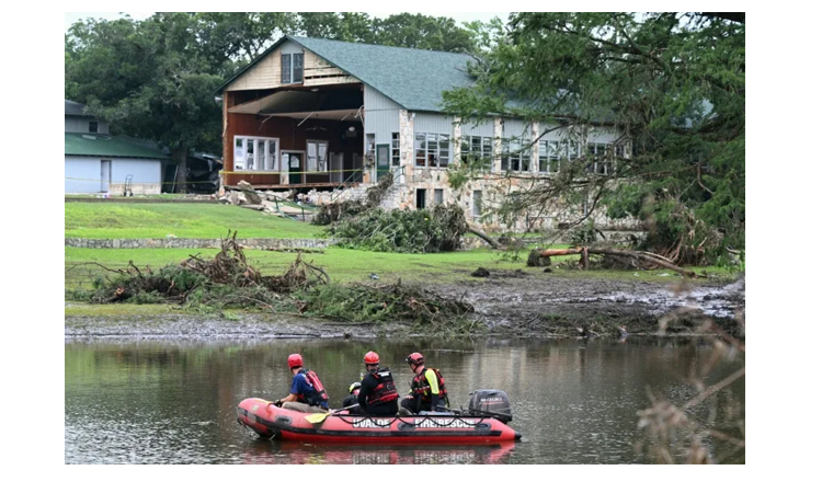 Rescuers on horseback, with dogs search for Texas flood victims