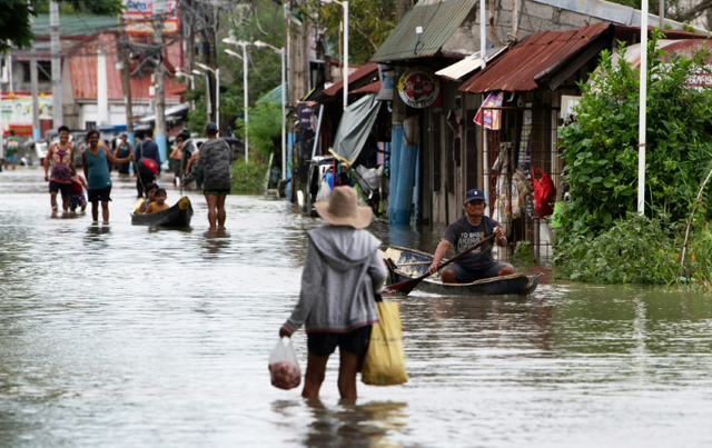 Boats bring food, safe passage for Philippine flood victims