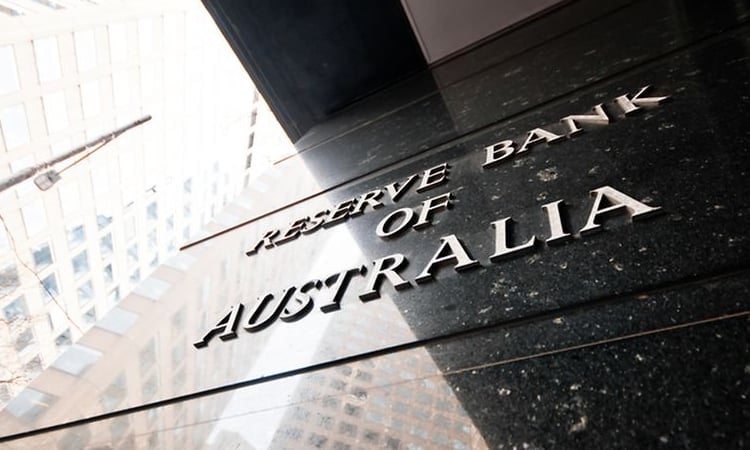 Australian central bank cuts key rate, warns of uncertainty