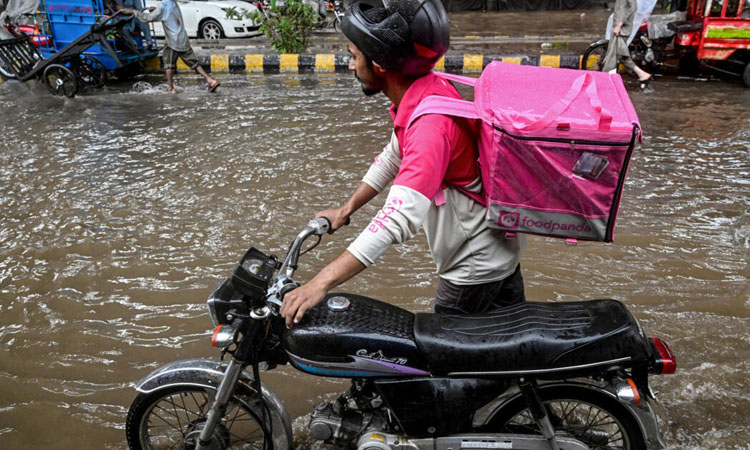 No pause for food delivery riders during Pakistan's monsoon