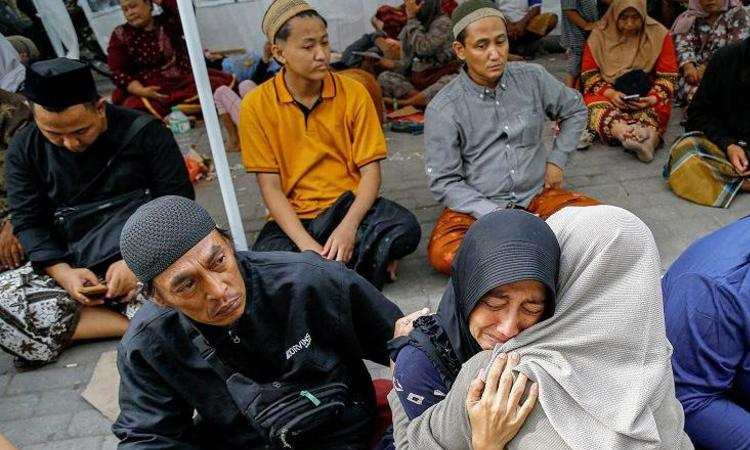 Indonesia families anxious for news after school collapse