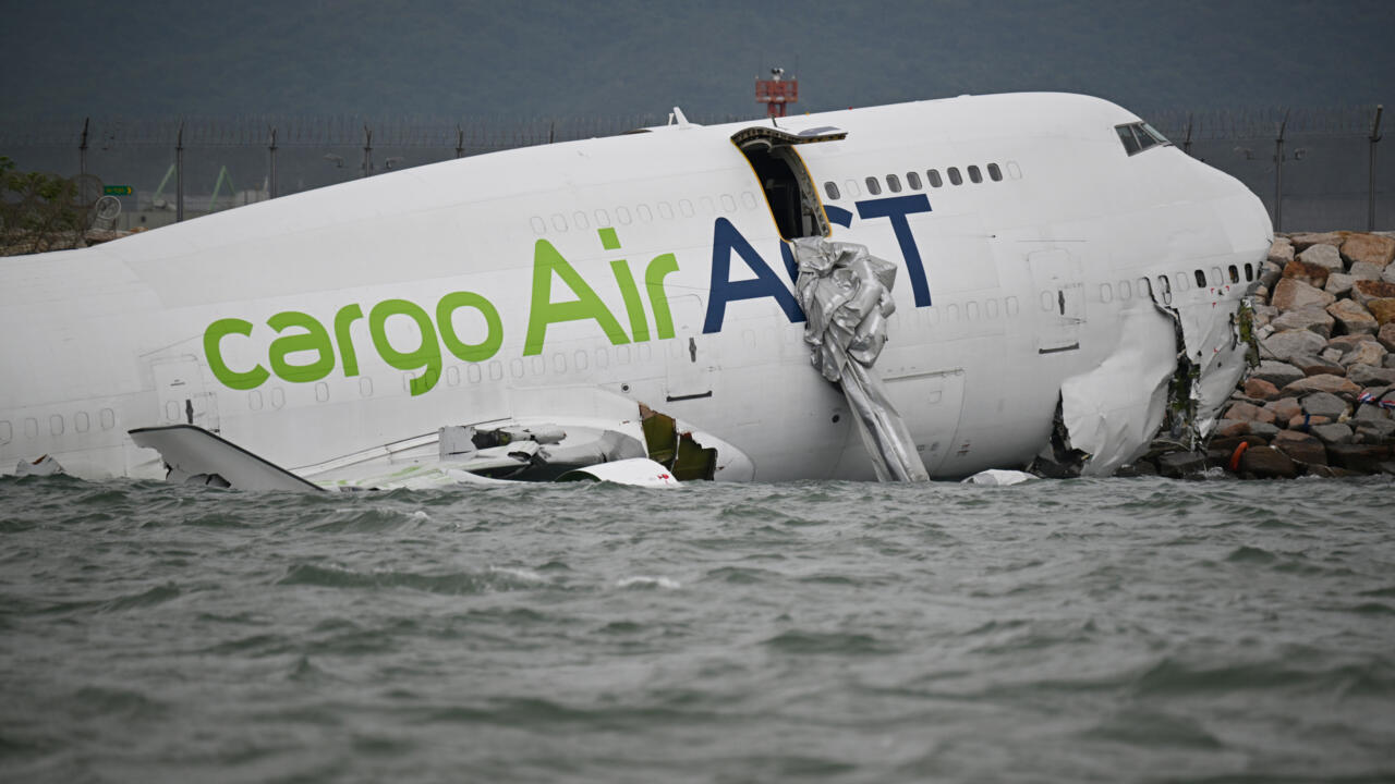 Cargo plane skids off Hong Kong runway, kills 2