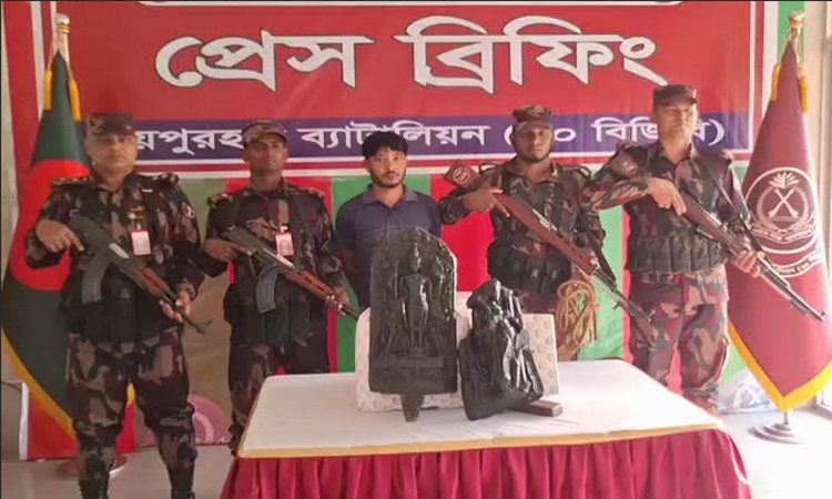 One held with two touchstone statues in Joypurhat