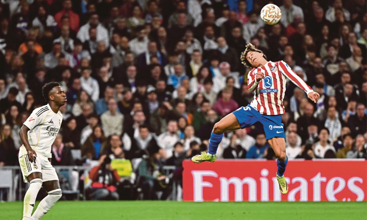 Vinicius double helps Real Madrid edge Atletico thriller